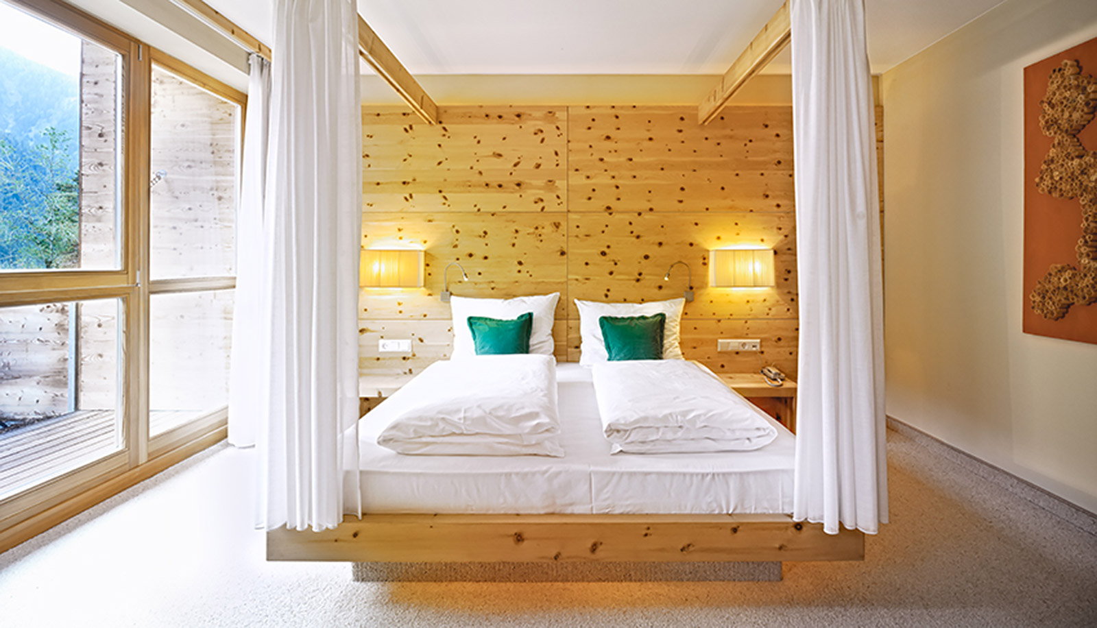 Double bed with wooden wall at Arosea Life Balance Hotel in Ultental-Val d'Ultimo